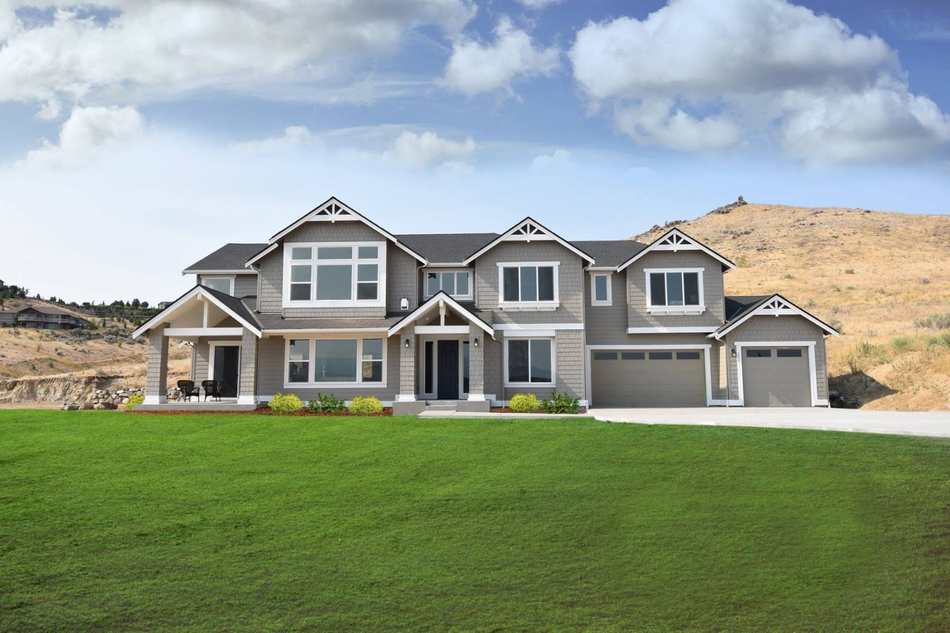Craftsman style home with manicured lawn and stone accents in Wenatchee, Washington